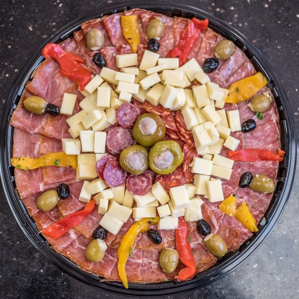 A large Nonna's Italian Deli & Market charcuterie platter with meats, cheeses, olives, and peppers.